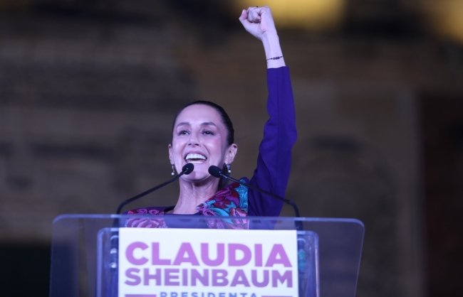 Claudia Sheinbaum with arm raised