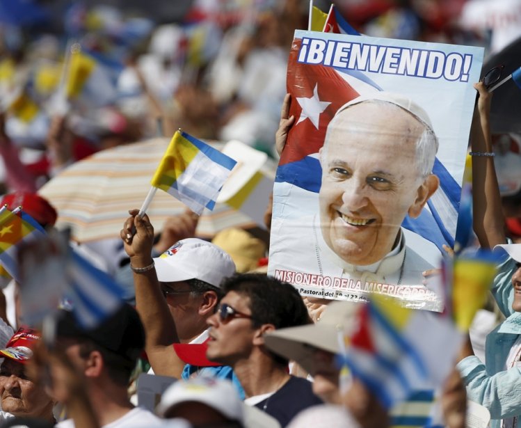 Catholic faithful cheer during the arrival of Pope Francis (not pictured) who will hold Mass in Holguin, Cuba, September 21, 2015