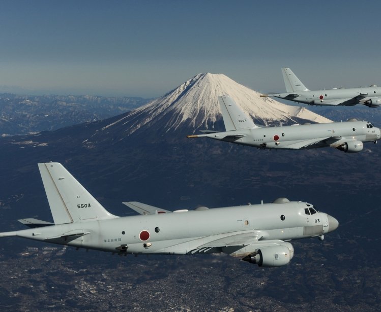 Three JMSDF planes in flight with Mount Fuji in the background.