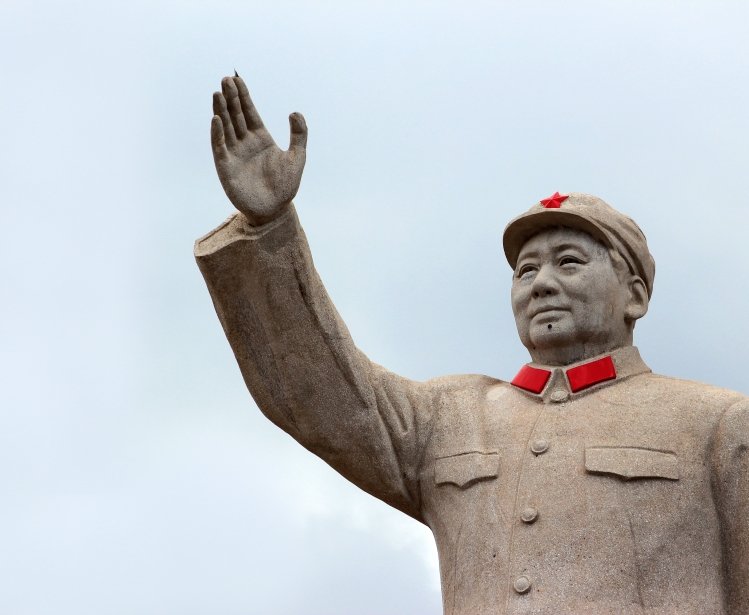 LIJIANG, CHINA, MARCH 8, 2012: Statue of Mao Zedong in central Lijiang. The city is famous for its UNESCO Heritage Site, the Old Town of Lijiang.
