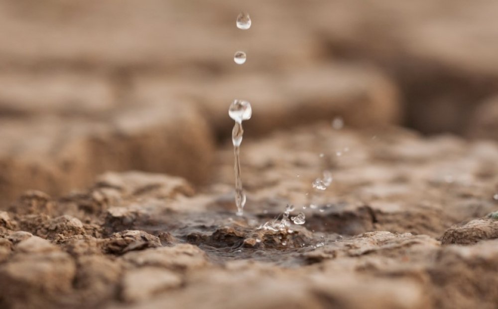 Water drop on dry cracked land