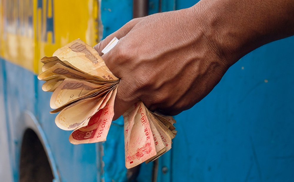 Man holding Indian Rupee notes