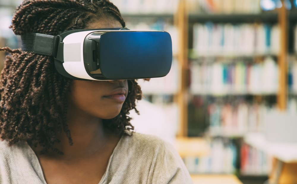 Student with headset on in a library