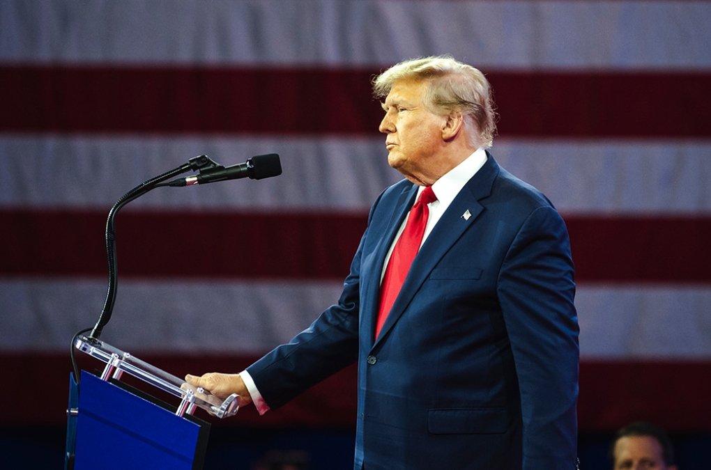 Donald Trump standing at a podium at an event.