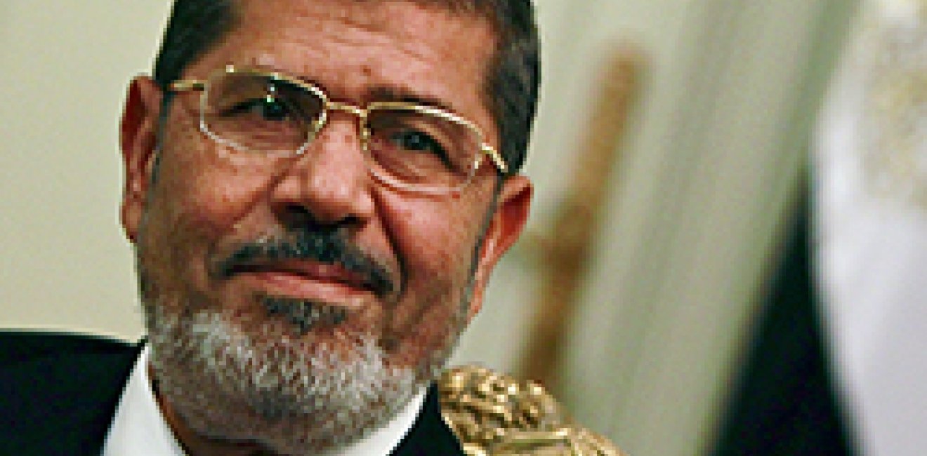 Egypt's first Islamist president Mohamed Mursi attends during his meeting with Turkish Foreign Minister Ahmet Davutoglu at the presidential palace in Cairo July 2, 2012. Egypt will approach the International Monetary Fund (IMF) and other financial institutions to help get its economy back on track once Mursi appoints a government, one of his financial advisers told Reuters. 