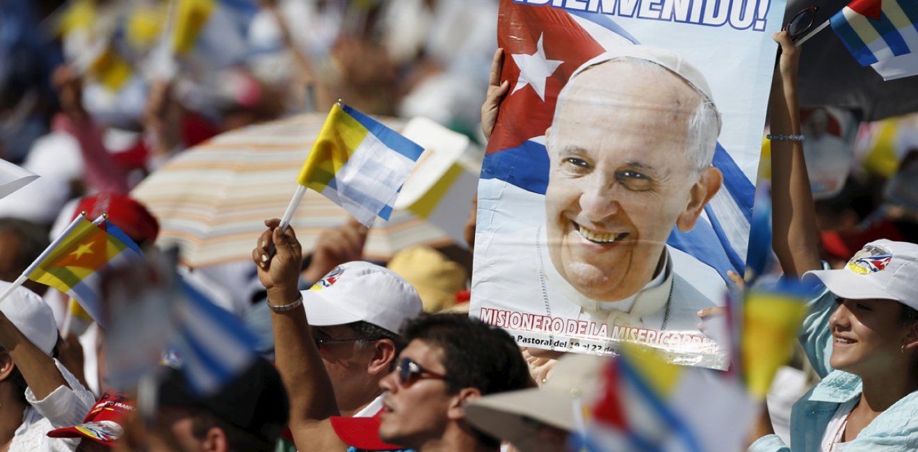 Catholic faithful cheer during the arrival of Pope Francis (not pictured) who will hold Mass in Holguin, Cuba, September 21, 2015