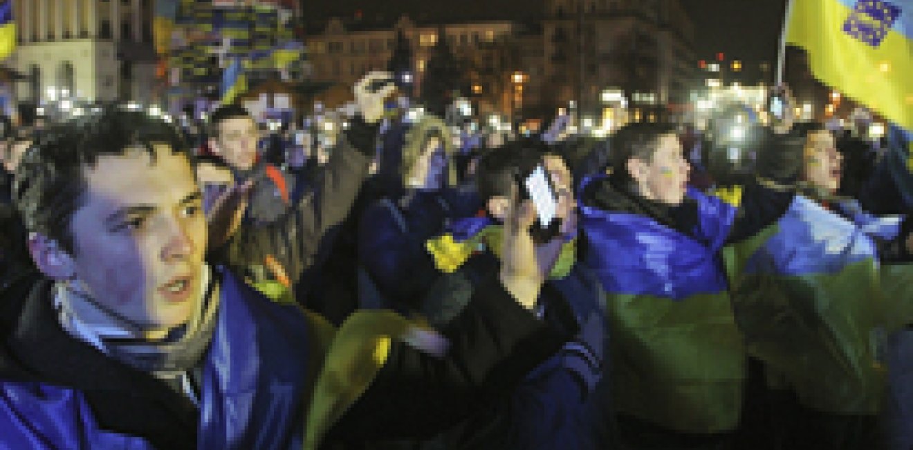 Supporters of Ukrainian EU integration shout slogans and wave flags during a protest on Independence Square in Kiev early December 6, 2013. 