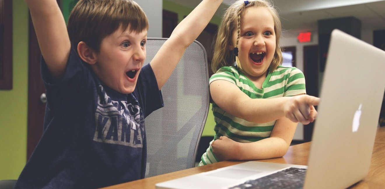 Children playing at a laptop computer