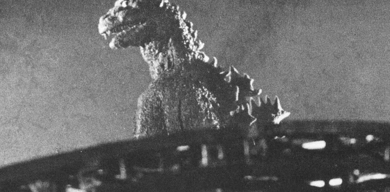 A behind the scenes shot of the 1954 Tōhō film Gojira, showing the original Godzilla as an ancient radiation-breathing monster awakened by the hydrogen bomb. Released months after the Lucky Dragon accident during the Castle Bravo test, the movie spoke to Japan's victimization by nuclear weapons." Source: Wikimedia Commons.