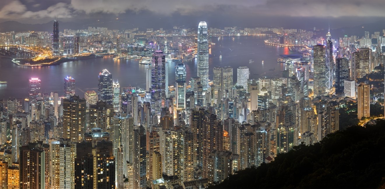 A panorama of the Hong Kong Island and Kowloon skyline at night,