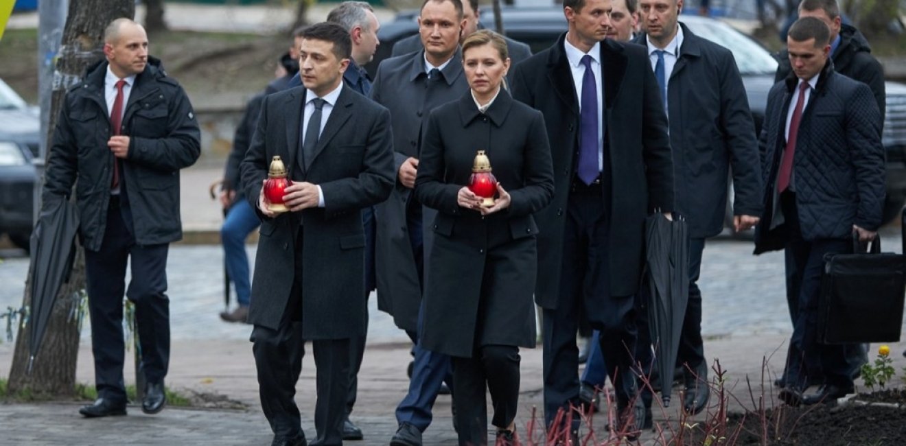 Ukrainian President Volodymyr Zelenskyy and his wife, Olena Zalenska, hold candles as they walk to a memorial in Independence Square in Kyiv, Ukraine. Source: President.gov.ua