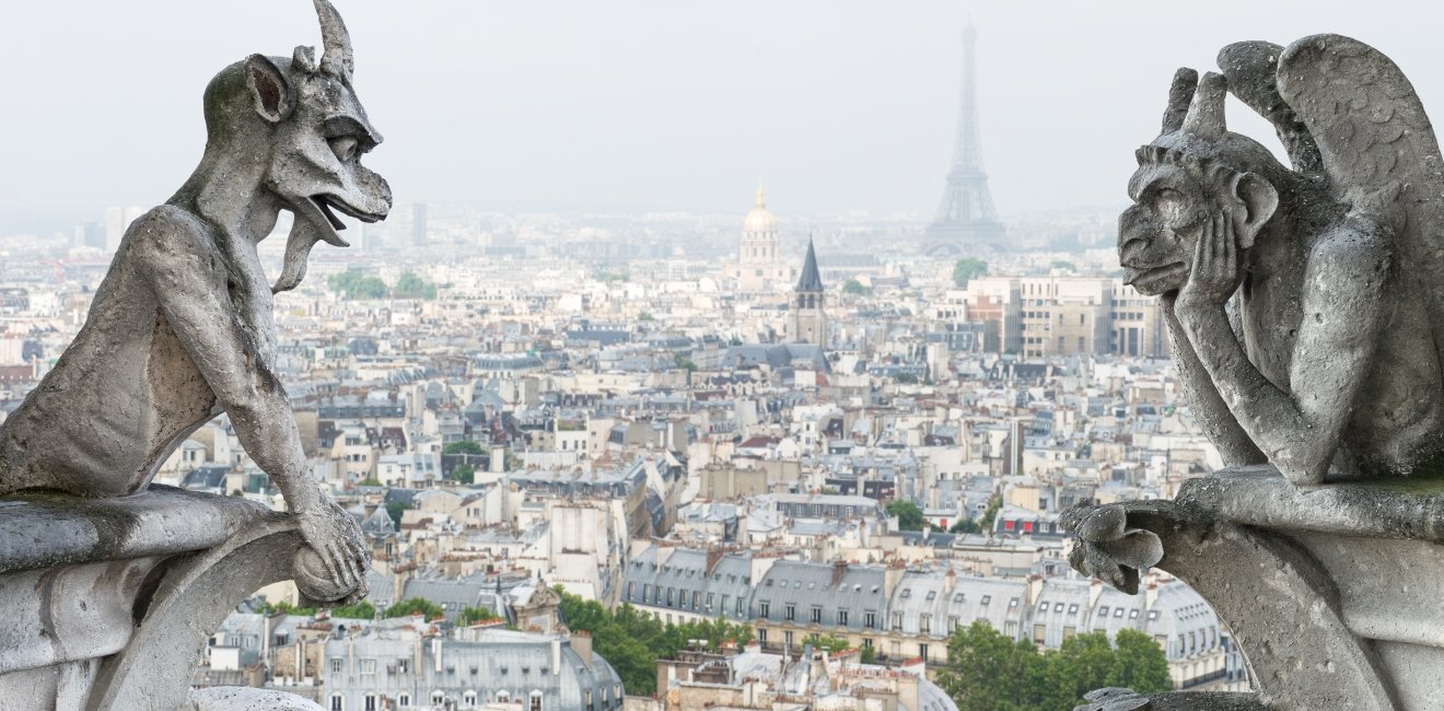 Stone gargoyle and chimera with Paris city on background. View from Notre Dame de Paris. Source: Shutterstock.