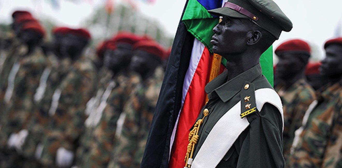 An officer holds the flag of South Sudan at the declaration of South Sudan's independence.