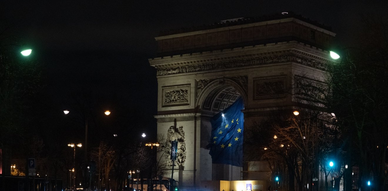 EU flag flying under the Arc de Triomphe