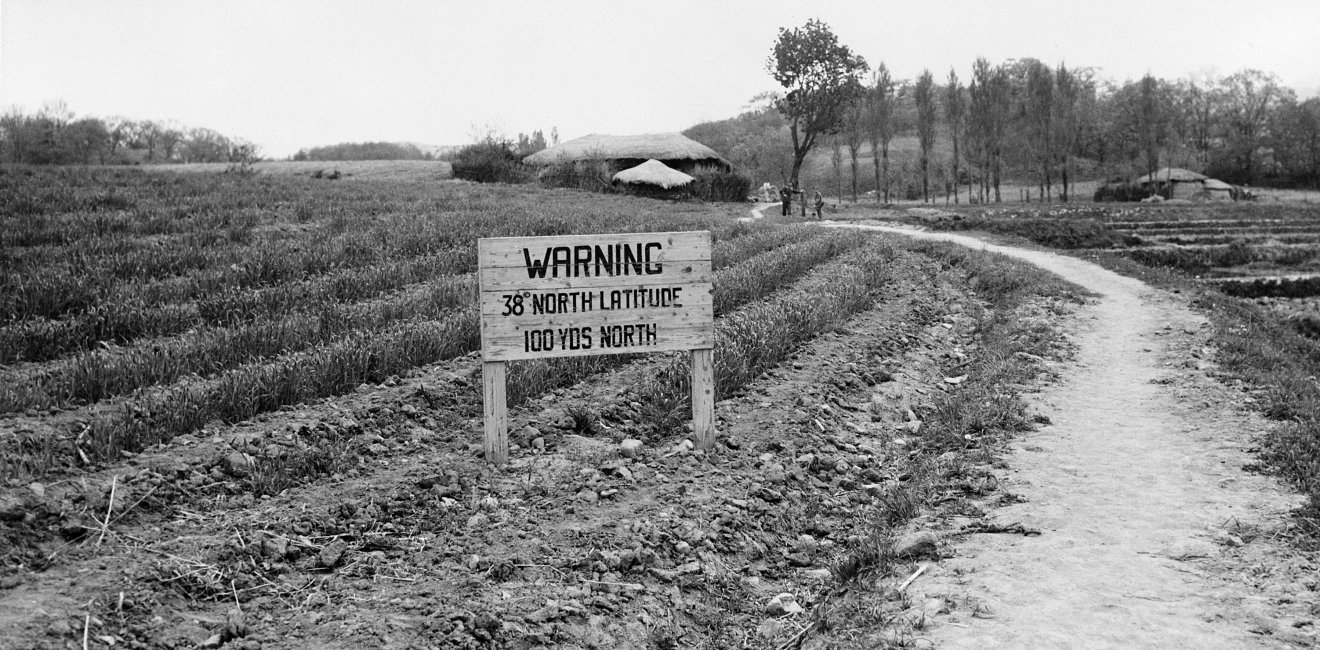 Sign reading, "Warning, 38th degree North Latitude 100 yards North".