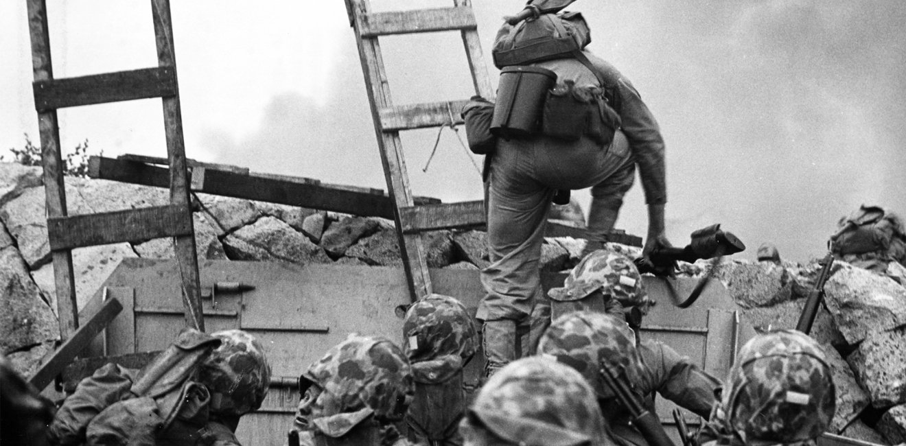 A soldier climbs over the seawall during the Inchon Landing in 1950.