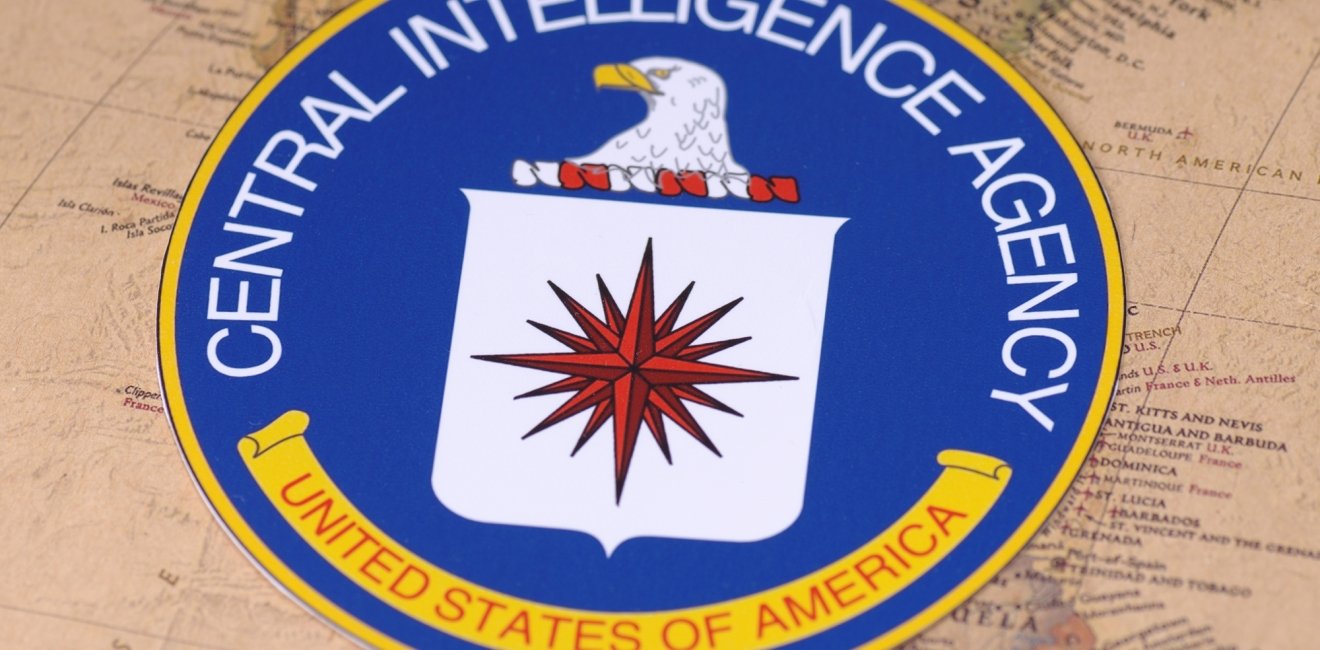 The seal of the CIA sitting on top of a map of North America