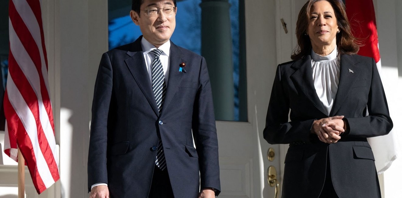 Japanese Prime Minister Fumio Kishida and U.S. Vice President Kamala Harris stand in front of a building.