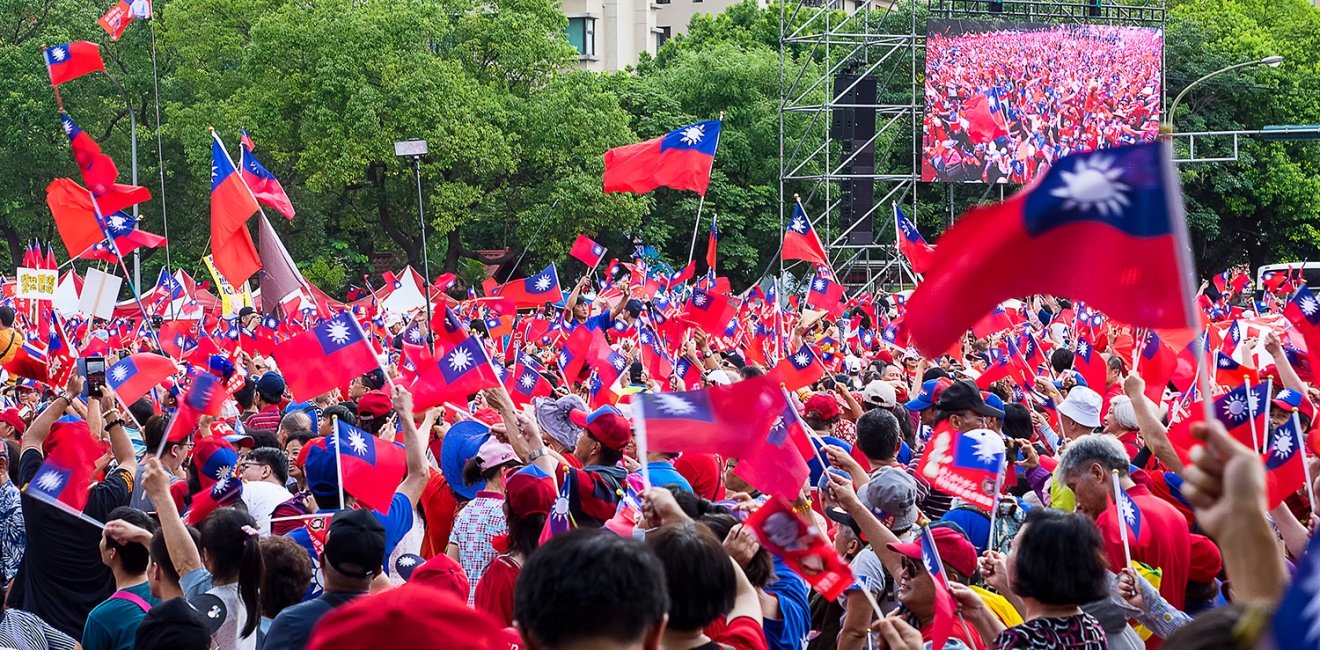 A large crowd at a rally holds up Taiwanese flags.