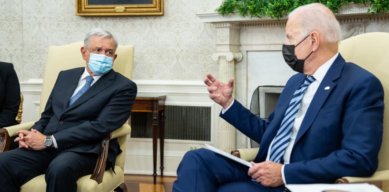 President Biden and President Lopez Obrador sit and talk. 