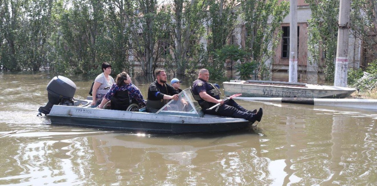 Group on boat in flooded area