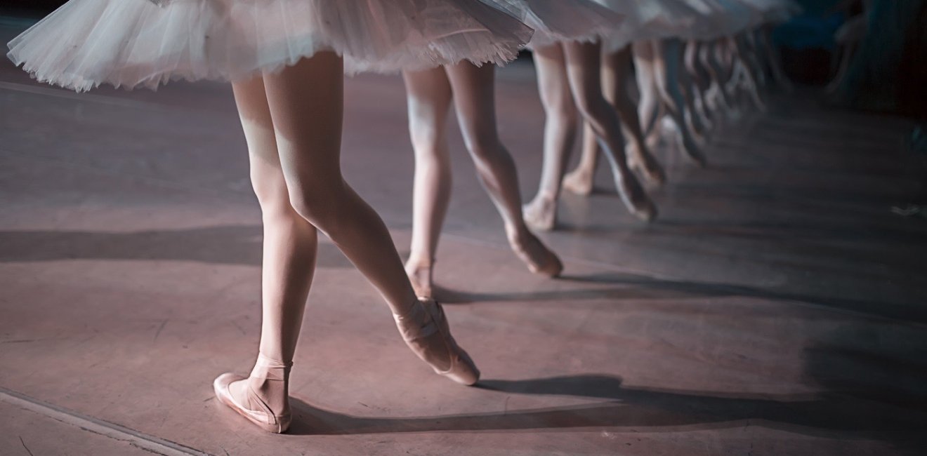 Dancers in white tutus performing swan lake