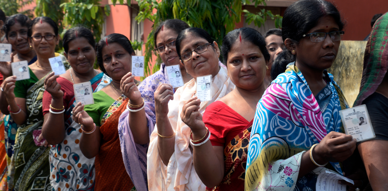 Indian women stand in queue with their Voter ID Card in hand during the West Bengal Three tier Panchayat Election approximate 40 k.m. from state capital Kolkata on May 14, 2018 in Hooghly, India.