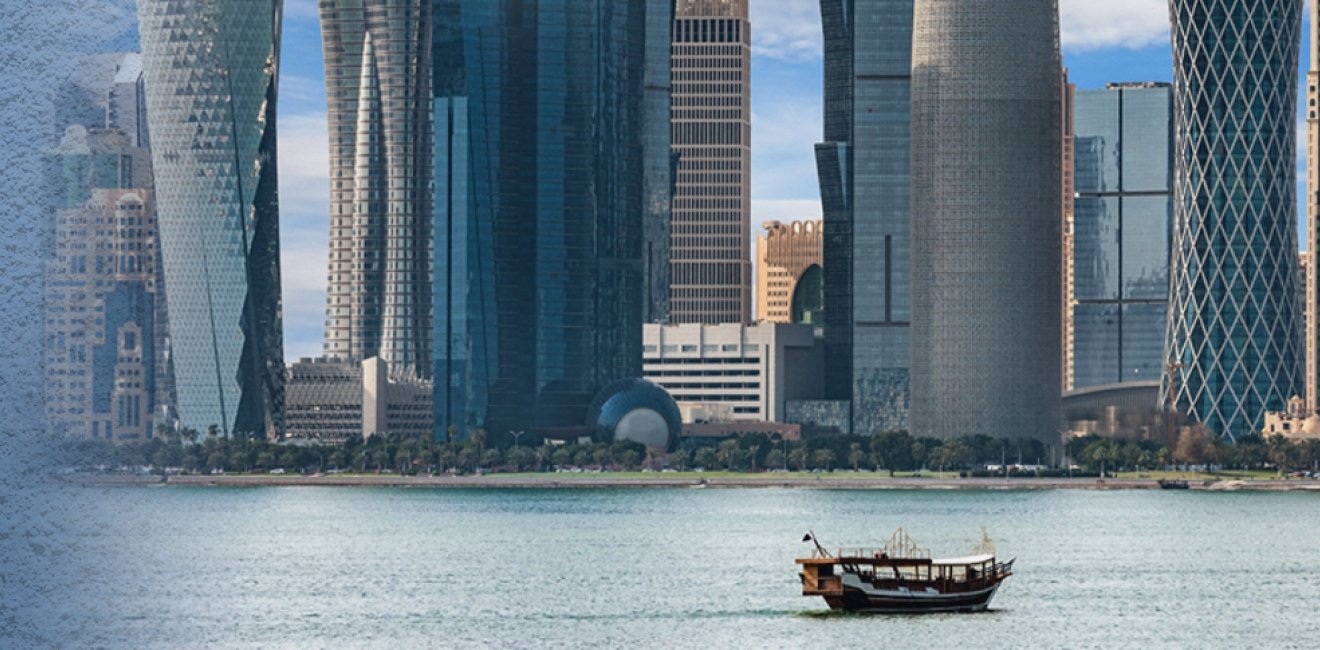 Boat in the water in front of large modern highrises