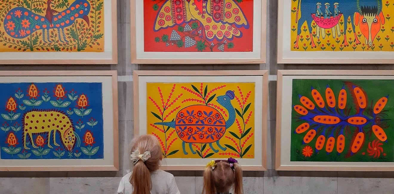 Two girls at an exhibition of paintings by Maria Prymachenko. 