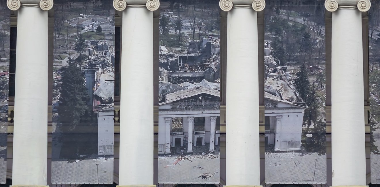 Theater facade, banner showing destroyed Mariupol Theater