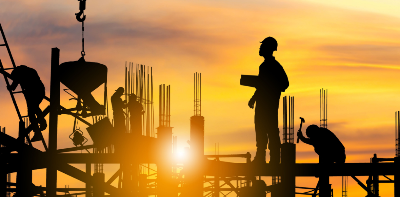 Silhouette of construction workers on site