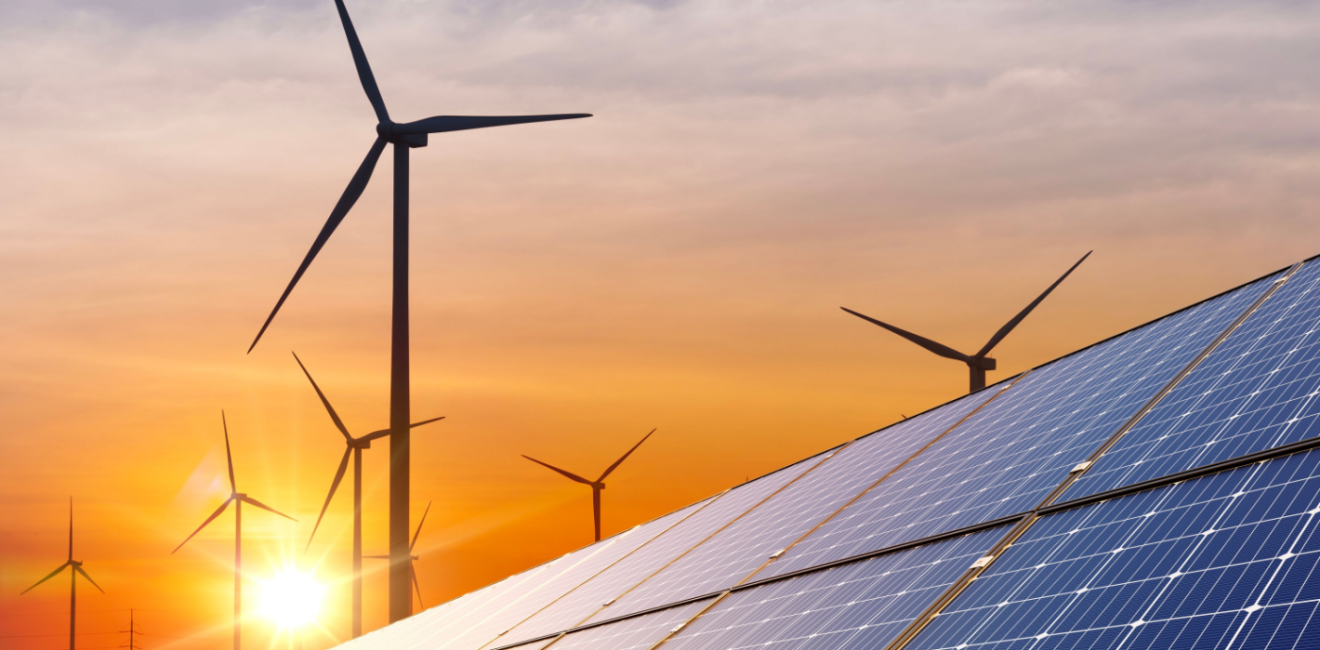 wind turbine with solar panels and sunset