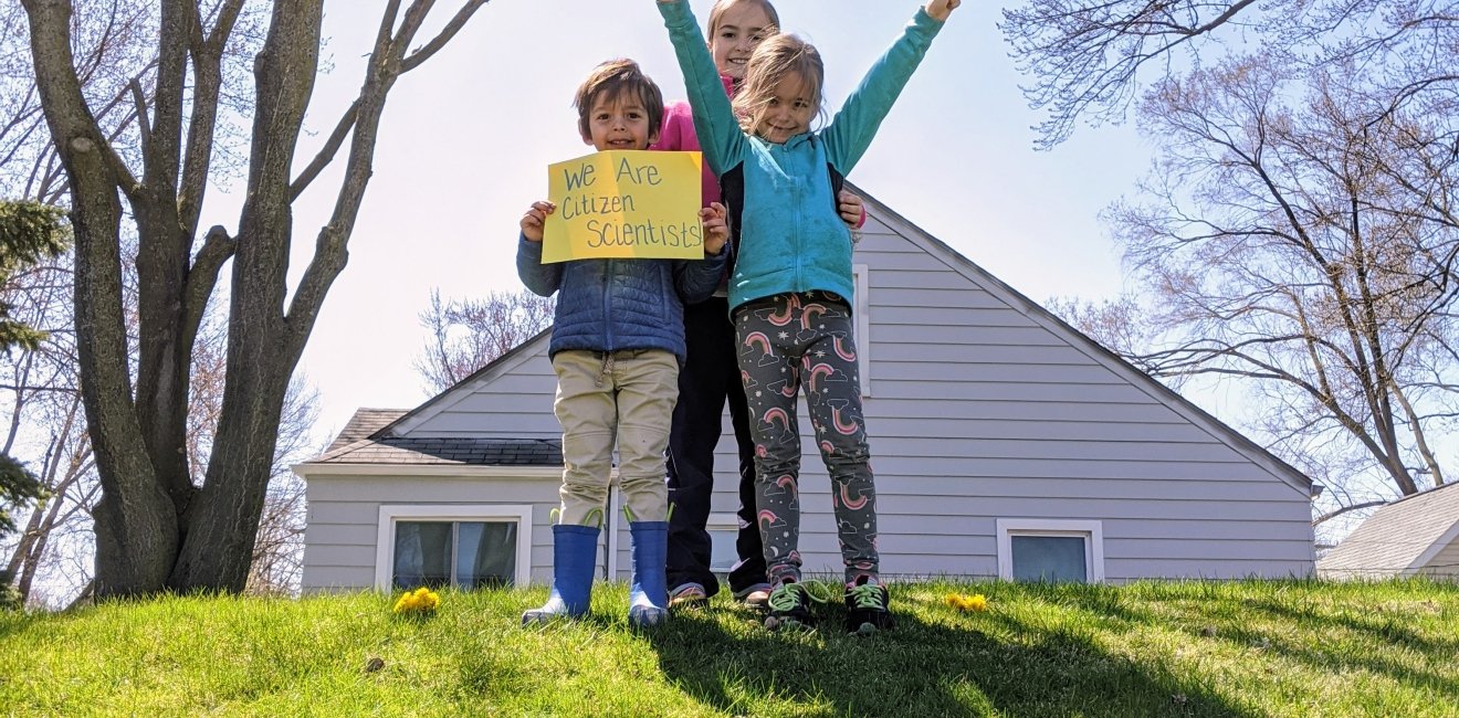 Children holding a sign of we are citizen scientists