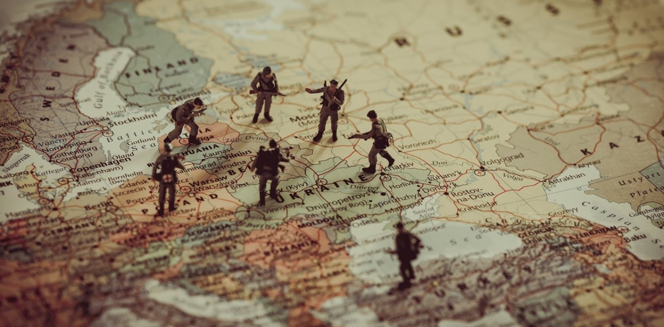 Toy soldiers stand on a map of Europe