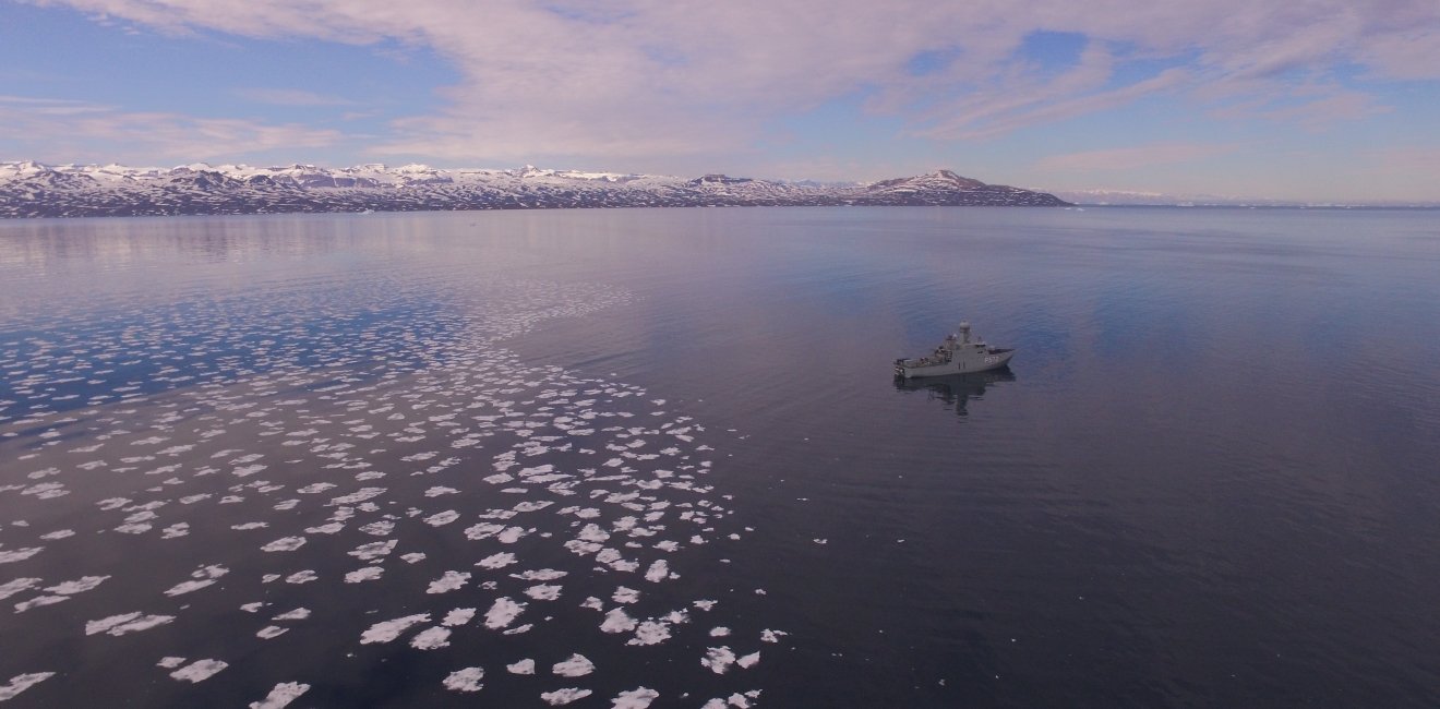 Photo of a ship sailing near ice