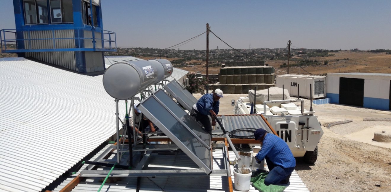 Workers installing solar power unit