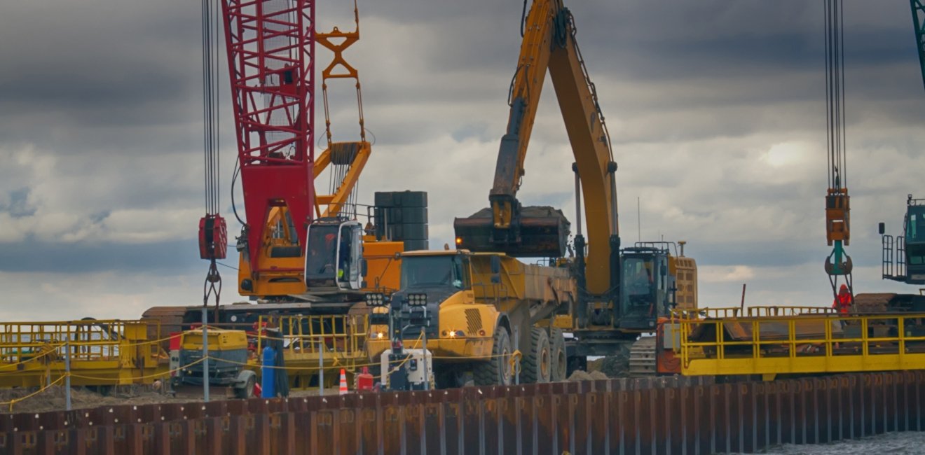 Construction of offshore section of gas pipeline on bottom of Baltic sea Nord stream-2. Pier goes into Narva Bay, excavator aligns bottom under bed of gas pipeline. Auxiliary vessels at sea.