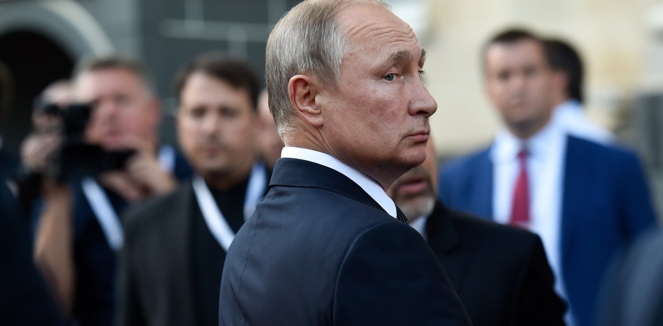 Vladimir Putin in profile looks over his shoulder