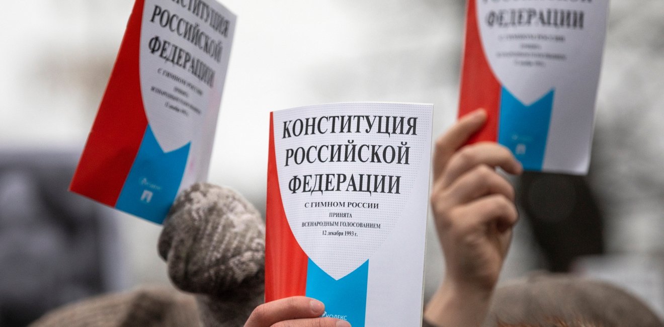 Opposition supporters hold a copy of Russia's constitution during a rally against constitutional reforms proposed by President Vladimir Putin in central Moscow.