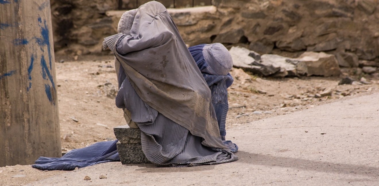 Afghan women in burqas on the side of the road