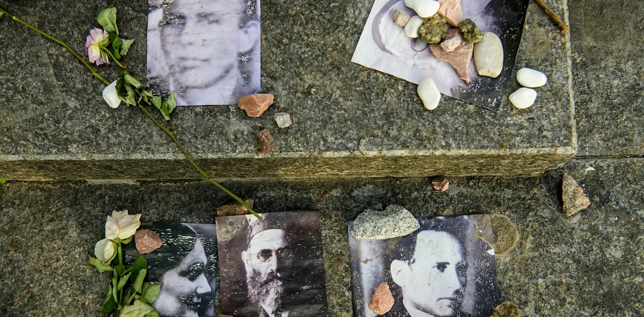 Portraits of killed Jews near Menorah monument in Memory of Jews Victims at the Babyn Yar National Historical Memorial. October 2020 Kyiv, Ukraine.