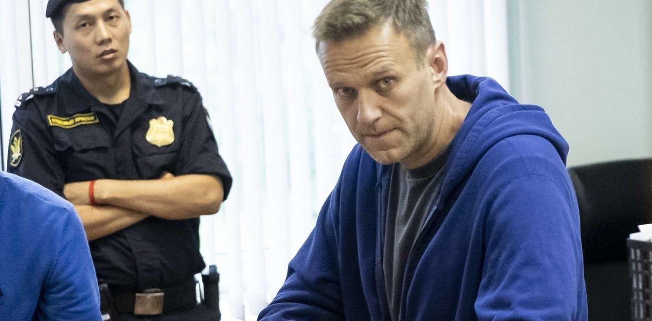 Russian opposition leader Alexei Navalny watched by a police officer, December 2020