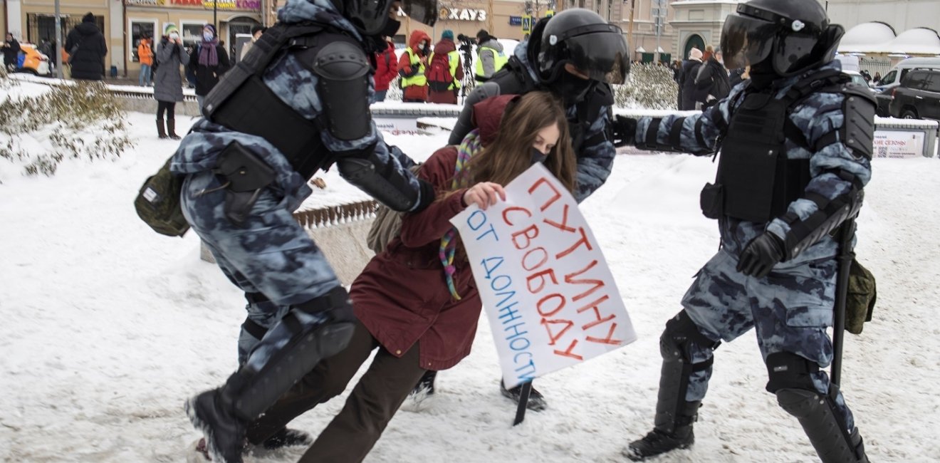 Police tackling a protester 