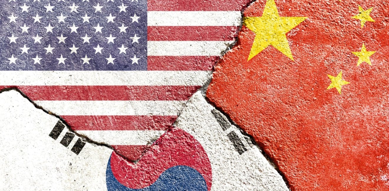 China, Korea, and US flags on concrete