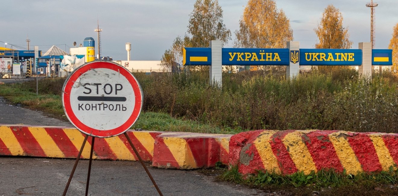 Control sign and concrete blocks at the entrance to the Ukrainian checkpoint from Russia