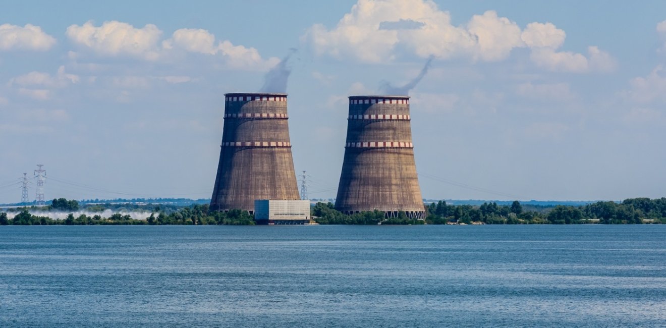 Image of nuclear power plant cooling towers across water