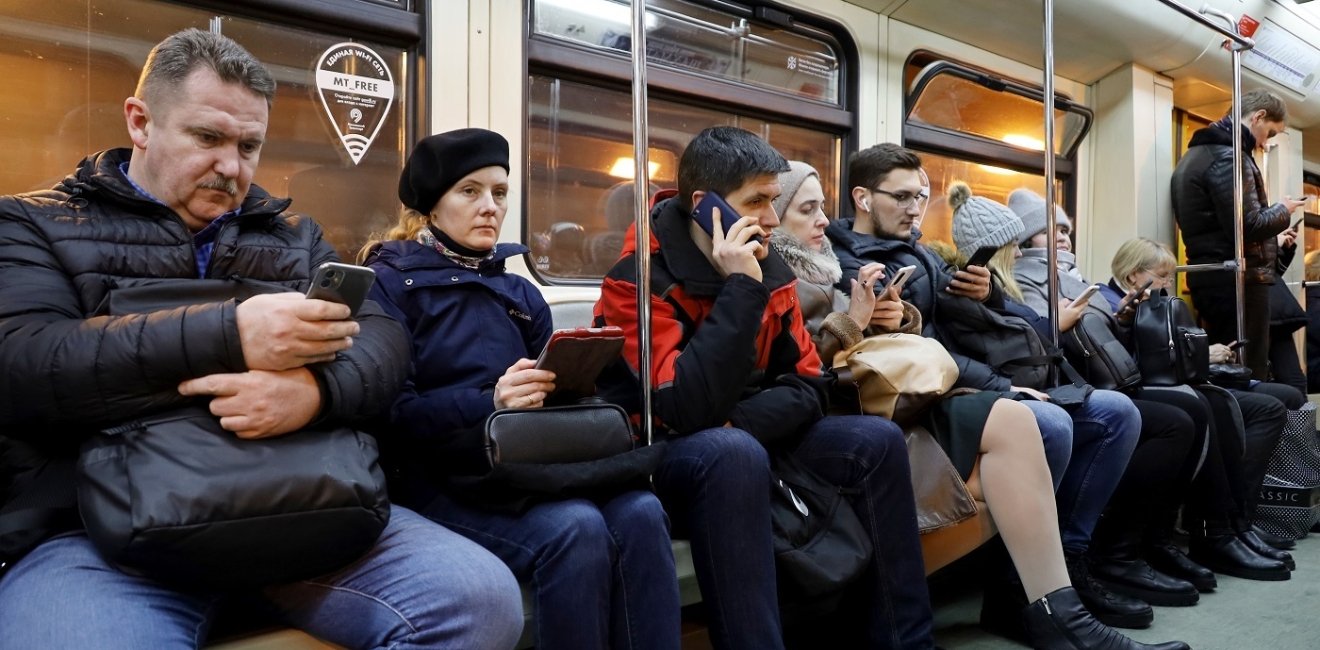 People sitting in a crowded train car