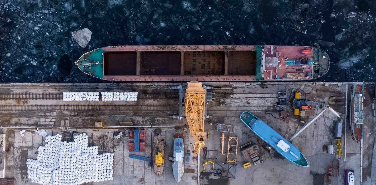 Aerial view from above of the river port with gantry cranes. Cranes in the cargo port of Togliatti in winter.