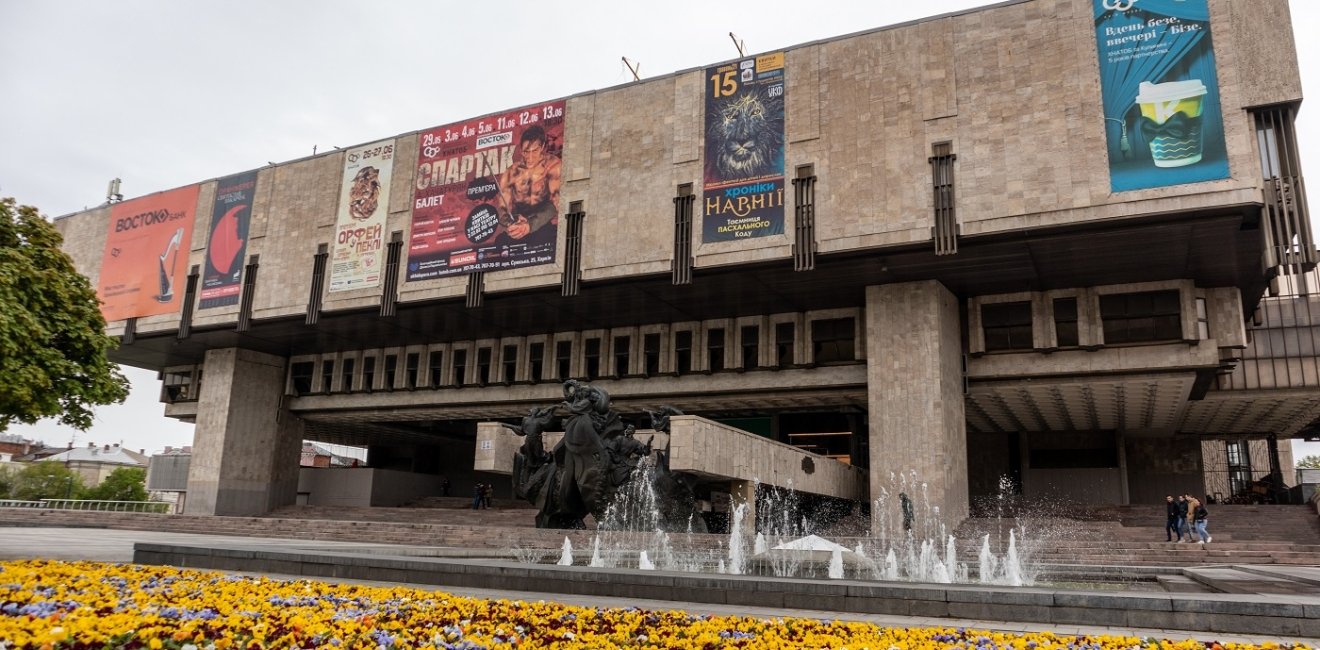 Kharkiv, Ukraine - May 08, 2021: The Kharkiv State Academic Opera and Ballet Theatre with fountains and vibrant pansies flowers blooming in spring