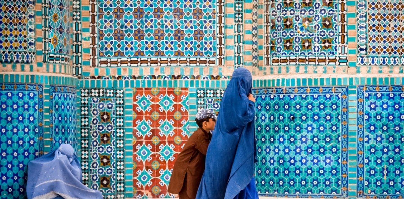 Afghan Women Walking in Front of Tiles